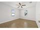 Bright bedroom with hardwood floors, ceiling fan, and two windows at 4755 21St N Ave, St Petersburg, FL 33713