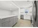 Modern kitchen featuring a spacious island, stainless steel appliances, white cabinets, and bright natural light at 4755 21St N Ave, St Petersburg, FL 33713