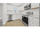 Bright kitchen featuring white cabinets, stainless steel appliances, subway tile backsplash, and marble countertops at 4755 21St N Ave, St Petersburg, FL 33713