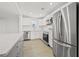Bright kitchen with stainless steel appliances, white cabinets, a kitchen island with marble countertops, and modern lighting at 4755 21St N Ave, St Petersburg, FL 33713