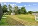 Large grass backyard with shed and white picket fence at 5112 Parkway Blvd, Land O Lakes, FL 34639
