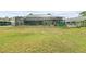A large, green backyard featuring a screened patio, perfect for outdoor entertaining at 5112 Parkway Blvd, Land O Lakes, FL 34639
