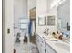 Bright bathroom equipped with double sinks, a shower, and ample storage, making it a functional and stylish space at 5112 Parkway Blvd, Land O Lakes, FL 34639