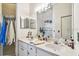 Bathroom featuring double sinks, a shower, and modern fixtures, designed for convenience and style at 5112 Parkway Blvd, Land O Lakes, FL 34639