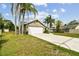 Inviting home with a 2-car garage, well-maintained lawn and landscaping, and a charming covered entryway at 5112 Parkway Blvd, Land O Lakes, FL 34639