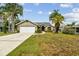 Charming one story home featuring mature trees, a well kept lawn, and an attached two car garage at 5112 Parkway Blvd, Land O Lakes, FL 34639