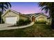 Charming single-story home with a manicured lawn, inviting curb appeal, and attached two-car garage at 5112 Parkway Blvd, Land O Lakes, FL 34639