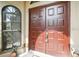 Elegant double front doors with sidelight windows, creating an inviting entry with natural light and charm at 5112 Parkway Blvd, Land O Lakes, FL 34639