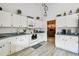 Well-lit kitchen boasts ample counter space, white cabinetry, and modern appliances, creating a functional and inviting culinary space at 5112 Parkway Blvd, Land O Lakes, FL 34639