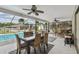 A dining table and chairs is set up in the patio overlooking the swimming pool at 5112 Parkway Blvd, Land O Lakes, FL 34639