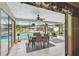 An open patio with ceiling fan, table, and chairs overlooks the beautiful blue swimming pool at 5112 Parkway Blvd, Land O Lakes, FL 34639