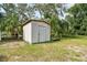 A simple, small shed in a yard lined with a white picket fence at 5112 Parkway Blvd, Land O Lakes, FL 34639