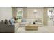 Comfortable living room with neutral tones, a plush sofa, and a large window offering serene views at 5724 Red Kite Dr, Wimauma, FL 33598