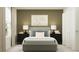 Neutral bedroom with a gray headboard, white bedding, and black bedside tables at 5724 Red Kite Dr, Wimauma, FL 33598