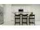 Bright kitchen with white cabinets, stainless appliances, and breakfast bar at 5731 Purple Finch Ave, Wimauma, FL 33598