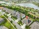 Aerial view of a lovely house with a driveway and solar panels near a lake and a road at 6016 Shadowlake Dr, Apollo Beach, FL 33572