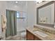 Bathroom featuring a granite countertop vanity and shower-tub with curtain at 6016 Shadowlake Dr, Apollo Beach, FL 33572