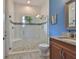 Well lit bathroom with decorative shower with a built-in seat and granite countertop sink at 6016 Shadowlake Dr, Apollo Beach, FL 33572