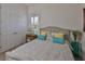 Comfortable bedroom with neutral colors, paisley comforter and pillows, and closet at 6016 Shadowlake Dr, Apollo Beach, FL 33572