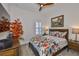 Cozy bedroom featuring a floral-patterned bed, wood furnishings, and decorative wall art at 6016 Shadowlake Dr, Apollo Beach, FL 33572