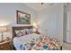 Cozy bedroom featuring a floral-patterned bed, wood furnishings, and decorative wall art at 6016 Shadowlake Dr, Apollo Beach, FL 33572