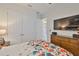Bedroom featuring double door closet and television at 6016 Shadowlake Dr, Apollo Beach, FL 33572