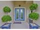 Welcoming entryway with a stylish blue double door, complemented by decorative plants in elegant blue pots at 6016 Shadowlake Dr, Apollo Beach, FL 33572