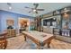 Entertaining game room with custom cabinetry, pool table and nearby dining room at 6016 Shadowlake Dr, Apollo Beach, FL 33572