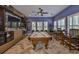 Enjoy a game of pool in this luxurious game room with custom built-ins and unique decor at 6016 Shadowlake Dr, Apollo Beach, FL 33572