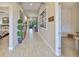 Bright hallway features elegant wood-look tile flooring and tasteful decor at 6016 Shadowlake Dr, Apollo Beach, FL 33572