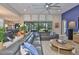 Open-concept living room with a large sectional sofa and access to the outdoor patio at 6016 Shadowlake Dr, Apollo Beach, FL 33572