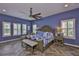 This primary suite features a large bed, herringbone floors, and plenty of natural light at 6016 Shadowlake Dr, Apollo Beach, FL 33572