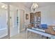 Bright office space with a unique chandelier, decor shelving, and wood look tile flooring at 6016 Shadowlake Dr, Apollo Beach, FL 33572