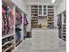 Spacious walk-in closet with custom shelving, storage drawers, and center island at 6016 Shadowlake Dr, Apollo Beach, FL 33572