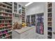 Spacious walk-in closet with custom shelving, storage drawers, and center island at 6016 Shadowlake Dr, Apollo Beach, FL 33572