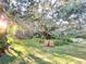 Lush backyard with mature trees and two wooden chairs at 6801 S Sparkman St, Tampa, FL 33616