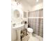 Bright bathroom with a pedestal sink, modern fixtures and patterned tile flooring at 6801 S Sparkman St, Tampa, FL 33616