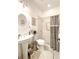 Bright bathroom with a pedestal sink, modern fixtures and patterned tile flooring at 6801 S Sparkman St, Tampa, FL 33616