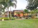 Beautiful single-story home with lush landscaping, mature palms, and excellent curb appeal at 6801 S Sparkman St, Tampa, FL 33616