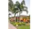 Well-maintained exterior with manicured landscape, mature palms, and brick paver walkway at 6801 S Sparkman St, Tampa, FL 33616