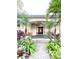 Inviting front entry featuring a covered porch, double doors, and beautifully landscaped surroundings at 6801 S Sparkman St, Tampa, FL 33616