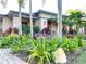 Lush landscaping with vibrant plants and a stone-accented walkway leading to the house at 6801 S Sparkman St, Tampa, FL 33616