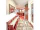 Hallway with a wooden bench that gives way to the kitchen, which has hardwood flooring at 6801 S Sparkman St, Tampa, FL 33616