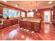 Open-concept kitchen featuring an island cooktop, stainless steel appliances, and warm lighting at 6801 S Sparkman St, Tampa, FL 33616
