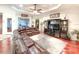 Spacious living area with a ceiling fan, home entertainment center, and hardwood floors at 6801 S Sparkman St, Tampa, FL 33616