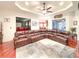 Living room featuring hardwood floors, a large leather sofa and a ceiling fan at 6801 S Sparkman St, Tampa, FL 33616