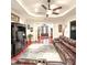 Spacious living room featuring a ceiling fan, wood floors, and an elegant area rug at 6801 S Sparkman St, Tampa, FL 33616