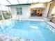 A pristine private pool surrounded by a screened enclosure at 6801 S Sparkman St, Tampa, FL 33616