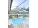 Enclosed pool area with manicured landscaping, perfect for outdoor relaxation and entertaining at 6801 S Sparkman St, Tampa, FL 33616