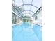 Enclosed pool area featuring a screened-in enclosure, providing a private and relaxing outdoor space at 6801 S Sparkman St, Tampa, FL 33616